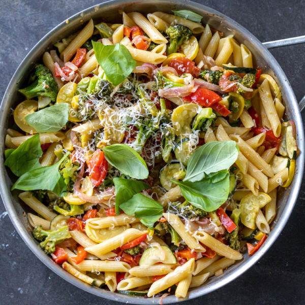 Cheese and basil added to pasta with veggies.