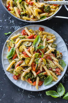 Pasta Primavera on a plate with herbs and parmesan.