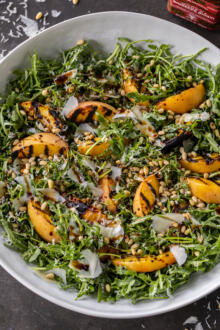 Peach Arugula Salad in a bowl.