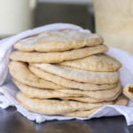 Cooked Sourdough Pita Bread layered on top of each other.
