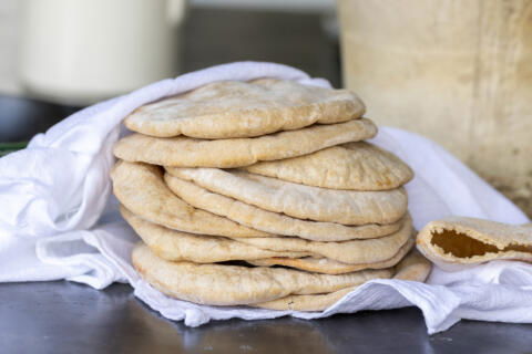 Cooked Sourdough Pita Bread layered on top of each other.