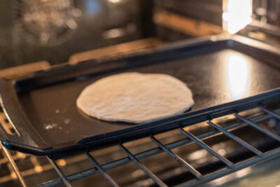 Pita cooking an oven.