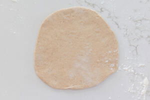 Rolled out pita on a counter.