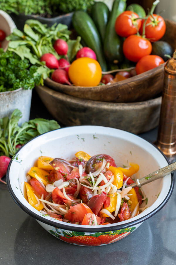 Bowl with Tomato Salad and other veggies next to it.