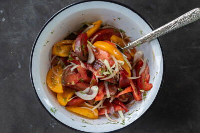 A bowl with Tomato Salad .