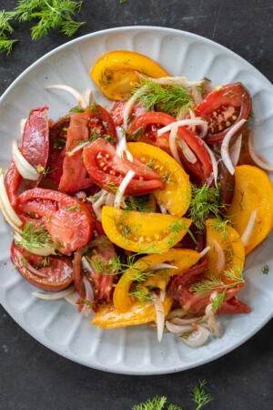Plated Tomato Salad with herbs.