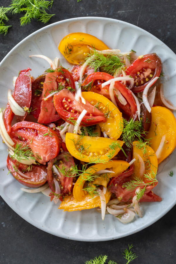 Plated Tomato Salad with herbs. 