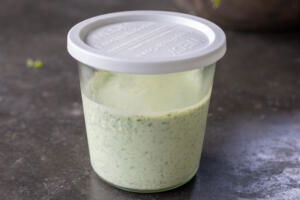 Green Goddess Dressing in a storage contianer.