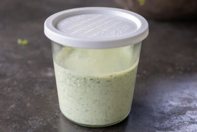 Green Goddess Dressing in a storage contianer.