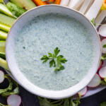 Green Goddess Dressing with veggies around.