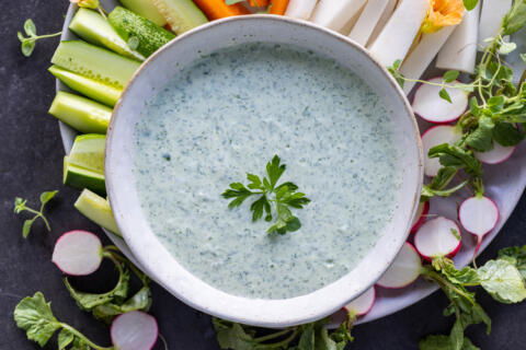 Green Goddess Dressing with veggies around.