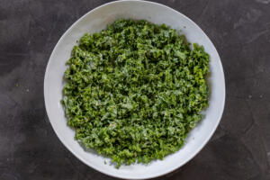 Kale with caesar dressing in a bowl.