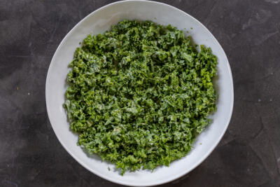Kale with caesar dressing in a bowl.