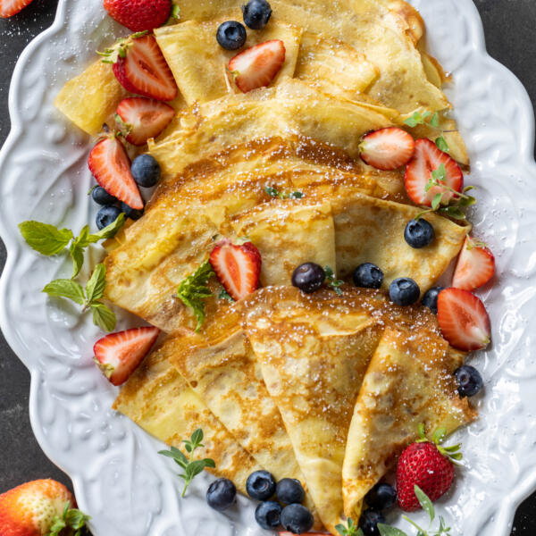 Sourdough Crepes on a plate with berries.