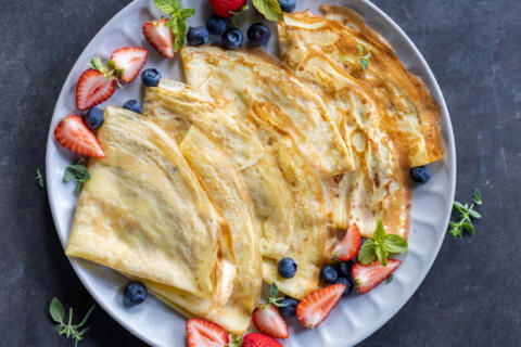 Plated Sourdough Crepes with berries around.