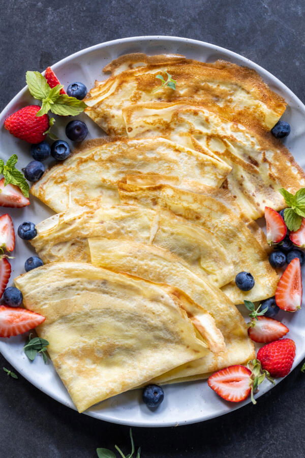 Sourdough Crepes with berries on a plate.