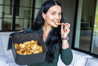 Natalya with air Fryer Waffle Fries in hand.