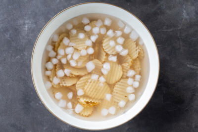 Waffle cut potatoes in ice water.