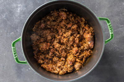 Beef with chili seasoning in a pot.