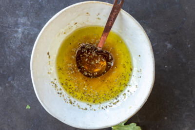 Mediterranean Farro Salad dressing in a bowl.