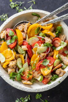 Plated Panzanella Salad with spoons.