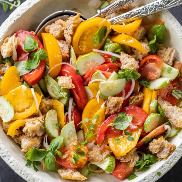 Plated Panzanella Salad with spoons.