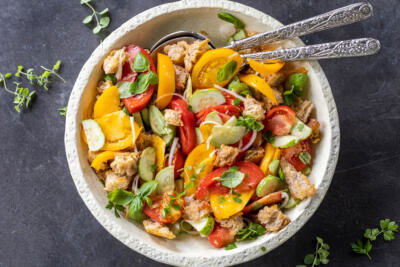 Plated Panzanella Salad with spoons.