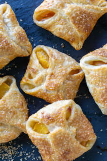Peach Turnovers with sugar aorund.