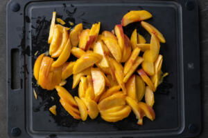 Peach slices on a cutting board.