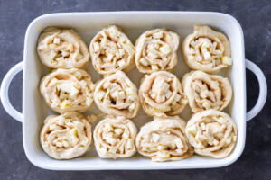 Apple Cinnamon Rolls raw in a baking dish.
