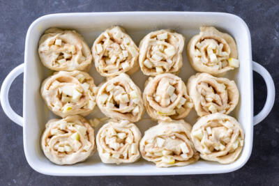 Apple Cinnamon Rolls raw in a baking dish.