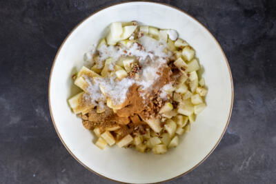 Apples sugar and cinnamon in a bowl.