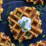 Crispy Mashed Potato Waffles with sour cream and herbs.