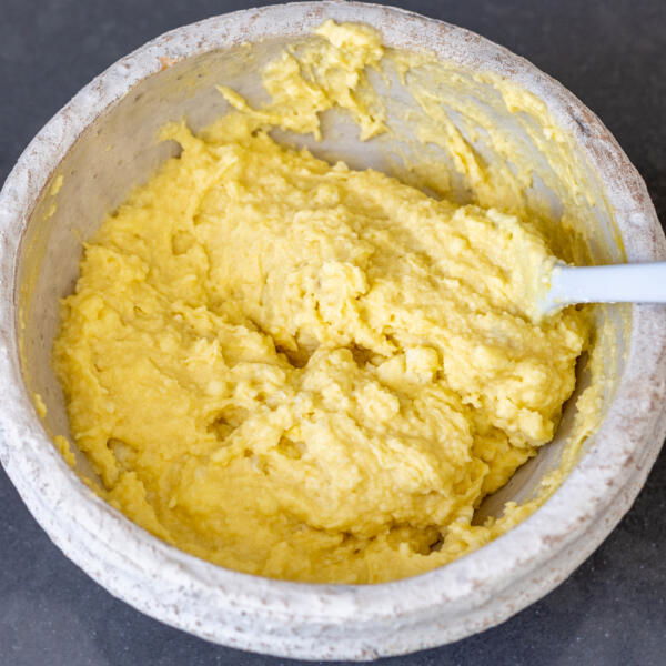 Combined flour, egg and mashed potatoes in a bowl.
