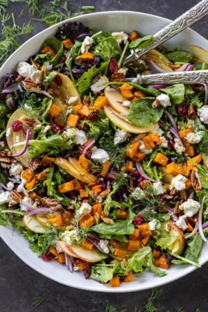 Harvest Salad in a serving bowl with spoons.
