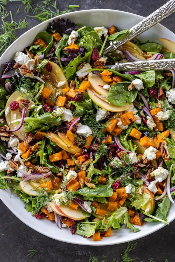 Harvest Salad in a serving bowl with spoons.