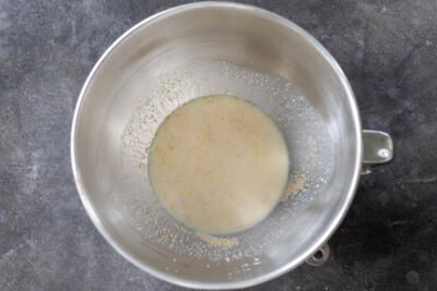 Milk, sugar and yeast in a mixing bowl.
