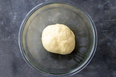 Kneaded dough in an oiled bowl.