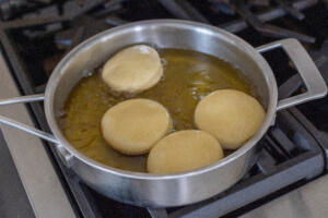 Fried donuts ina pan.