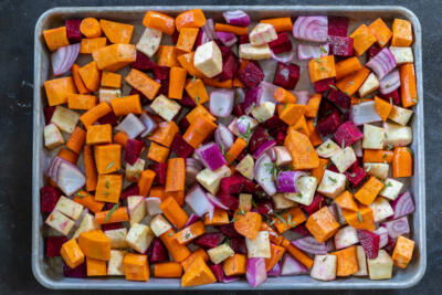 Seasoned veggies on a baking sheet.