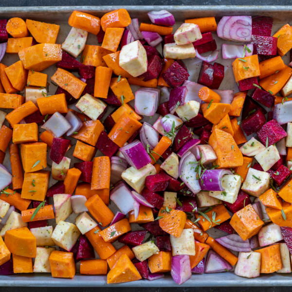 Seasoned veggies on a baking sheet.
