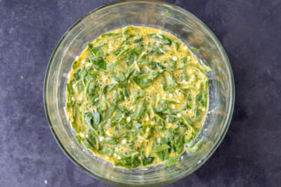 Ingredients all in a bowl for Cottage Cheese Egg Bake.