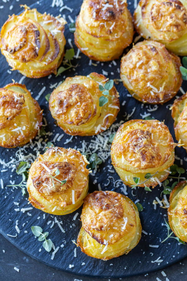 Potato Stacks on a serving tray with herb and parmesan.