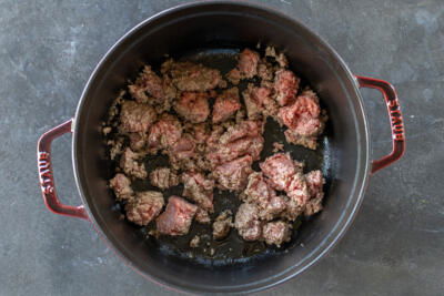 Ground beef cooking in a cocotte.