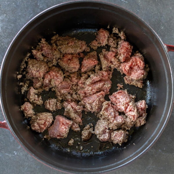 Ground beef cooking in a cocotte.