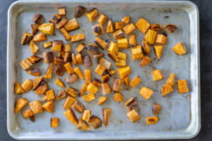 Roasted Cubed Sweet Potatoes on a baking dish.
