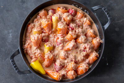 Stuffed Mini Peppers with sauce before cooking.