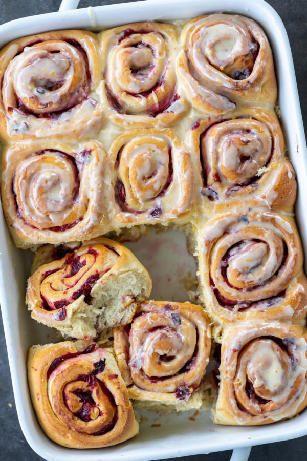Cranberry Cinnamon Rolls with Orange Glaze in a baking pan. 