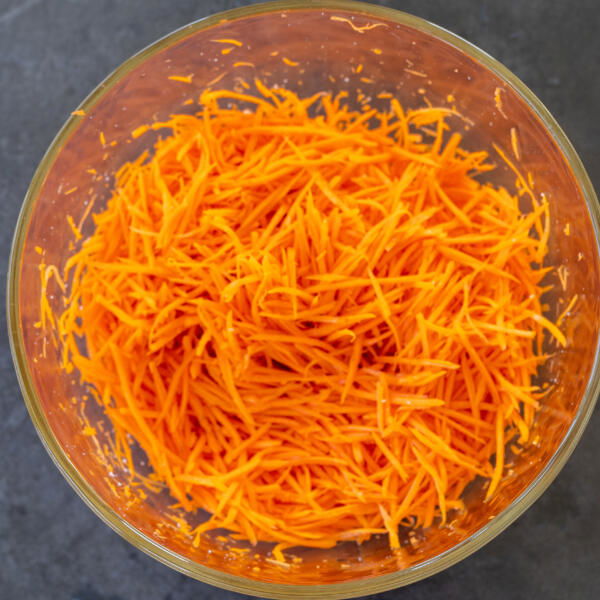 Shredded carrots in a bowl.
