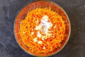 Carrots, sugar, salt and vinegar in a bowl.